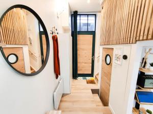 a hallway with a mirror on the wall at Hyper-Centre Studio Lekain UnSejourANantes in Nantes