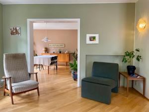 a living room with a chair and a dining room at Adorable Húsavík home nearby the harbor in Húsavík