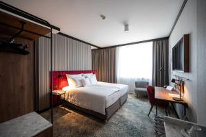 a hotel room with a large bed and a desk at Hotel Kossak in Krakow +97 photos