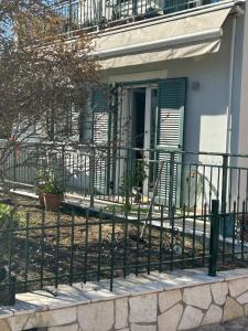 a fence in front of a house with a door at Thermos House Nydri in Nydri