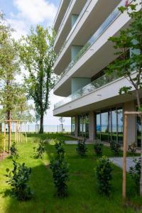 a building with trees in front of it at Summer Vibe Siófok - Wave in Siófok