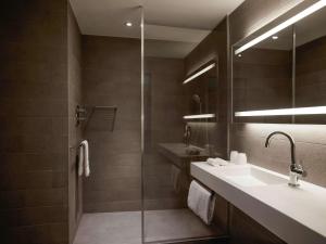 a bathroom with a sink and a shower at Pullman Paris Tour Eiffel in Paris