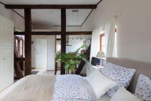 a bedroom with a large bed with pillows at Wilkenburger Pfarrscheune Hannover Hemmingen in Hemmingen