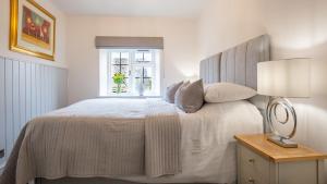 Ένα ή περισσότερα κρεβάτια σε δωμάτιο στο Gordon Cottage