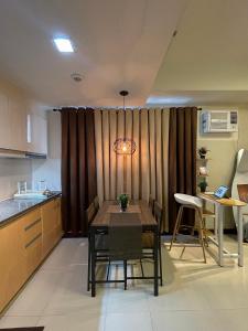 a kitchen and dining room with a table and chairs at NAIA Terminal 3 Condo Newport with WIFI Netflix Pool in Manila +99 photos