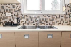 a kitchen counter with a sink in a kitchen at K&Ε guest house in Ampavris +42 photos
