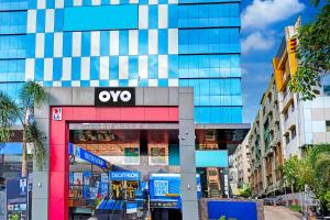 a building with an ovy sign on it in a city at Super Hotel O Botcha Convection in Visakhapatnam