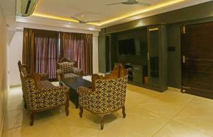 a dining room with a table and chairs and a television at Super Hotel O Botcha Convection in Visakhapatnam
