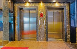 two elevators in a subway station with the number eight at Super Hotel O Botcha Convection in Visakhapatnam
