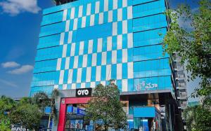 a tall glass building with a sign on it at Super Hotel O Botcha Convection in Visakhapatnam