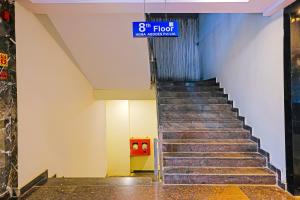 a staircase in a building with a sign that reads floor at Super Hotel O Botcha Convection in Visakhapatnam