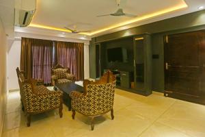 a dining room with a table and chairs and a television at Super Hotel O Botcha Convection in Visakhapatnam