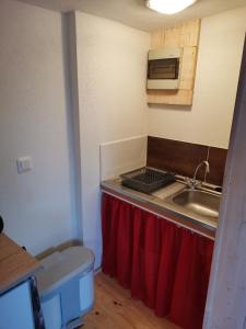 a small kitchen with a sink and a microwave at Ferienhaus Mühlberg 4 in Braunschwende +15 photos