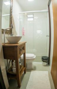a bathroom with a sink and a toilet at Casa container in Tramandaí