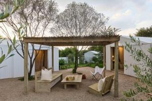 a backyard with a pergola and a table and chairs at FARMHOUSE58 in Krugersdorp