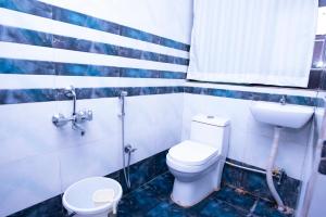 a bathroom with a toilet and a sink at Hotel Hill View in Guwahati