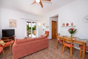 a living room with a couch and a table at Olive Grove Villas - Villa Maria in Chorafakia
