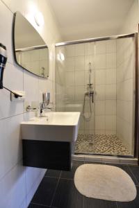 a bathroom with a sink and a shower at Vila Kelmyne in Molėtai