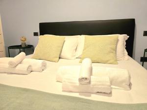 a white bed with towels on top of it at Russomanno Apartments 6 in Como +18 photos