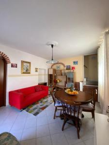 a living room with a red couch and a table at Pierina in Lucca
