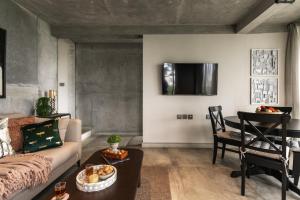 ein Wohnzimmer mit Sofa und Tisch in der Unterkunft LohonoStays Amani Villa 11B in Coonoor