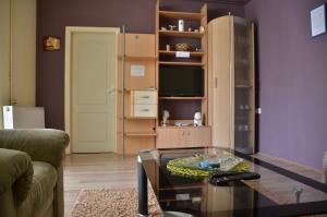 a living room with a glass table and a tv at Smestaj na Drini in Bajina Bašta