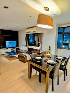 uma sala de estar com uma mesa e um sofá em High Floor Great View 2BR 2BA 3 mins to Nana BTS em Banguecoque