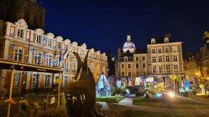 a group of buildings in a city at night at La Cachette des Murmures- Balnéo Privée I Détente in Boulogne-sur-Mer