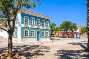 a blue and white building on a street at Casa Blue in Silves