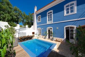 a blue house with a swimming pool in front of it at Casa Blue in Silves