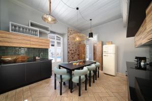 a kitchen with a table and chairs and a refrigerator at Casa Blue in Silves