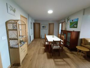 a living room with a table and chairs and a dining room at Casa Filo in Redondela