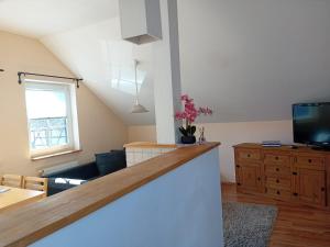 a living room with a couch and a tv at Stellas Monteurwohnungen in Dennheritz