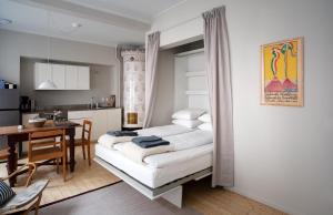 a kitchen and a living room with a couch and a table at Gamla Stan Apartments in Stockholm
