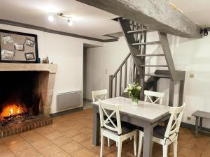 a dining room with a table and a fireplace at Maison de charme avec jardin, animaux acceptés, WiFi - FR-1-491-388 in Saint-Lubin-en-Vergonnois