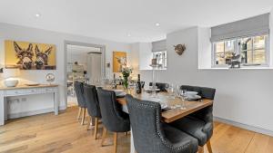 a dining room with a table and chairs at Vine Cottage in Campden Station