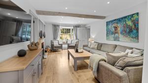 a living room with a couch and a table at Vine Cottage in Campden Station +14 photos
