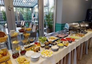 a buffet line with food on a table at Sentoza Sopot in Sopot
