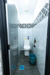 a small bathroom with a toilet and a shower at Akiera Homestay #MELAYU ONLY in Pelabohan Klang