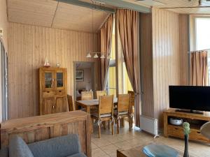 a living room with a table and a television at Seeschwalbe 69A in Rechlin