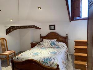 a bedroom with a bed with a pillow on it at Pensión Gijonés in Cangas de Onís