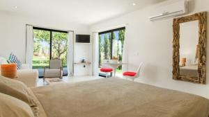 a bedroom with a large bed and a mirror at charming studio in the house of Envi's house in Sant Josep +9 photos