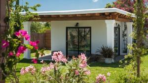 a small white house with a wooden roof at charming studio in the house of Envi's house in Sant Josep