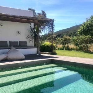a swimming pool in front of a house at charming studio in the house of Envi's house in Sant Josep