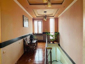 a hallway with chairs and a table in a room at Aero Hotel Tour Armenia in Pʼarakʼar