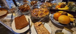 a table topped with different types of bread and desserts at Abadia Samitier in Mediano +16 photos