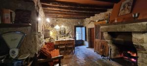 a living room with a fireplace and a dining room at Abadia Samitier in Mediano