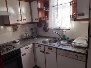 a kitchen with a sink and a counter top at Piso acogedor con vistas in Val do Dubra +23 photos