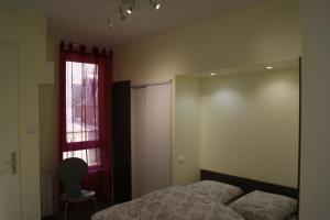 a bedroom with a bed and a mirror and a window at Simple Asile in Mers-les-Bains