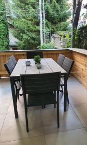 a wooden table and chairs on a patio at LUNA RESIDENCE TERRACE Sinaia in Sinaia
